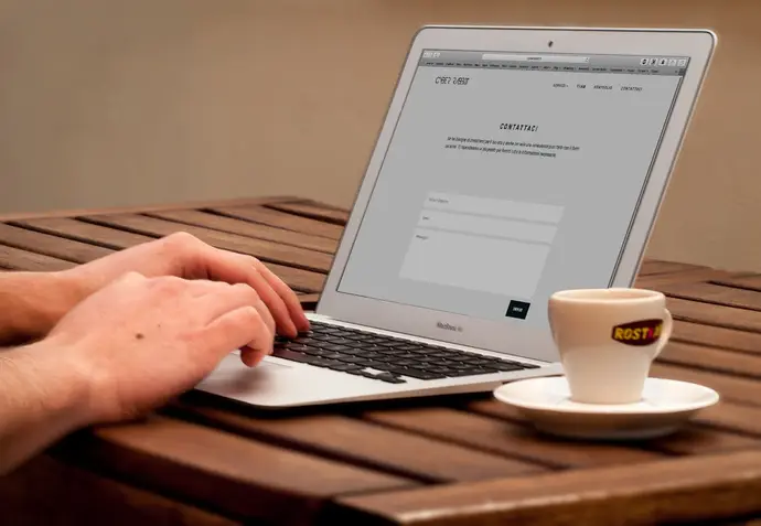 Person checking website accessibility on laptop