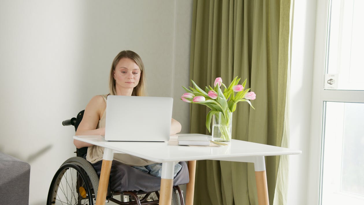 Small business owner reviewing website accessibility settings on a laptop
