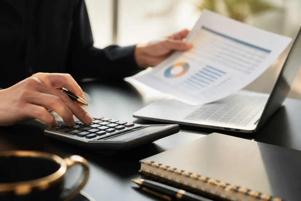 Marketing analyst calculating cost per acquisition at a desk